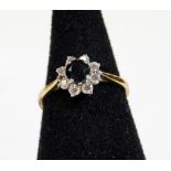 A 9ct gold dress ring, florally set with claw set blue stones surrounded by paste, size O, 2.4g