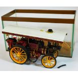 A cased model of a Cox's Upto Date amusement vintage steam tractor, in Perspex case, 23cm high, 42cm