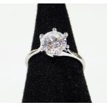 A sterling silver solitaire ring, claw set on plain shank marked 925 CZ, size O.
