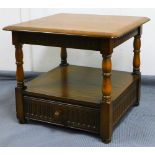 A late 20thC Ercol side table, the shaped top on turned legs with a drawer beneath, 50cm high,