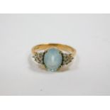 A 9ct gold and aquamarine ring, claw set, with six diamond set shoulders, size N, 2.7g