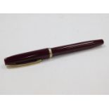 A Sheaffer fountain pen, in burgundy with banding and shaped clip, and partially enclosed nib,