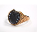A Victorian gentleman's 9ct gold and black onyx horseshoe ring, size T, Birmingham 1886, 2.7g.