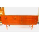 A vintage teak sideboard, with button and nasal shaped handles, with three long drawers flanked to