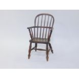 A 19thC oak and elm child's Windsor chair, raised on turned legs, united by an H frame stretcher,
