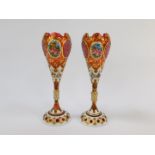 A pair of late 19thC Bohemian flashed cranberry glass vases, of ogee form, raised on a
