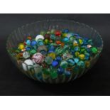 Assorted marbles, in a glass bowl.