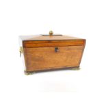 A Regency mahogany and ebony line inlaid tea caddy, of sarcophagus form, with twin lion's head and
