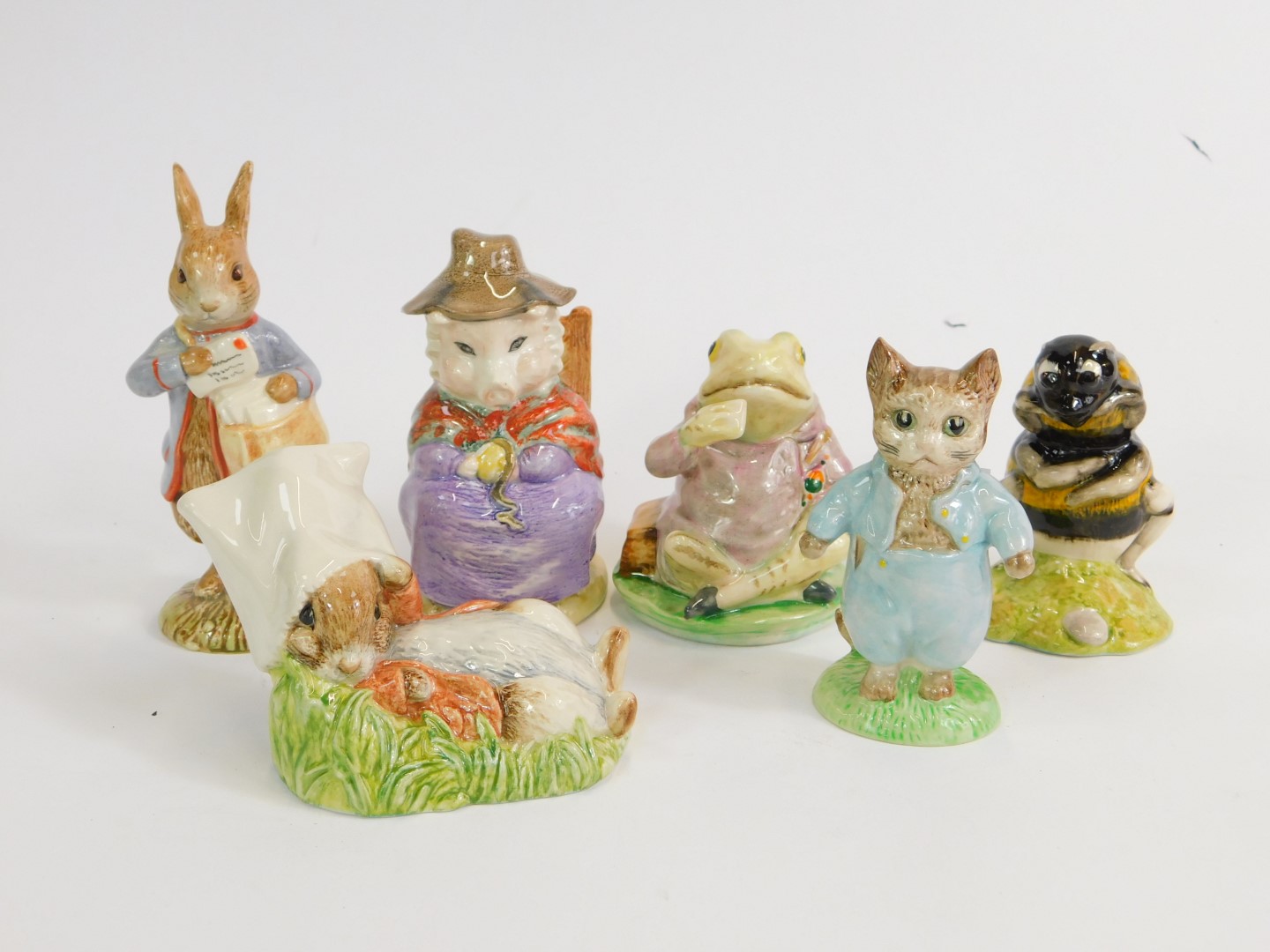 Six Royal Albert Beatrix Potter figures, comprising Peter with post bag, And This Pig Had None,