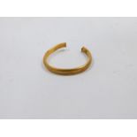 A 22ct gold wedding band, cut, 2.3g.