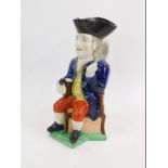 An early 19thC pearlware character jug modelled as The Squire, pipe lacking, 28cm H.