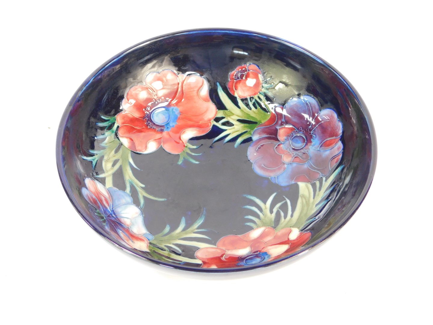 A Moorcroft pottery bowl decorated in the Anemone pattern, against a cobalt blue ground, painted and - Image 2 of 3