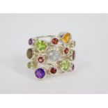 A silver and gemstone ring, in a kaleidoscope setting, with amethyst, rhodolite garnet, mozenbique