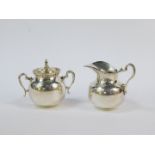 A Mexican silver cream jug and sugar bowl, with a crimped rim, stamped Sterling, 8.48oz.