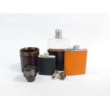 A 20thC cut glass and leather bound hip flask, two stainless steel and leather bound hip flasks, a