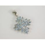 A silver and Sokoto aquamarine pendant, the marquise cut aquamarine in a floral setting, 3.25ct,