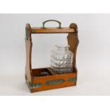 A Victorian oak and brass bound two bottle tantalus , containing a single cut glass decanter and