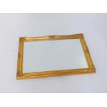 A rococo style rectangular gilt wood wall mirror, inset bevelled glass, 88cm H, 62cm W.