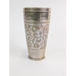 An early 20thC Middle Eastern beaker, engraved with script, a caravan type vehicle, trees and