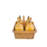 A set of four Victorian stoneware two tone spirit jars, in a four division wicker basket, comprising