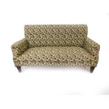 A Victorian two seater sofa, upholstered in olive and cream fabric, decorated with fruit and leaves,
