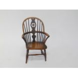 A 19thC child's oak and elm wheel back Windsor chair, 60cm high.