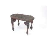 An Anglo Indian late 19thC hardwood occasional table, of canted rectangular form, the top carved