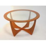 A G-Plan 1960's circular teak occasional table designed by Victor Wilkins, inset glass, raised on an