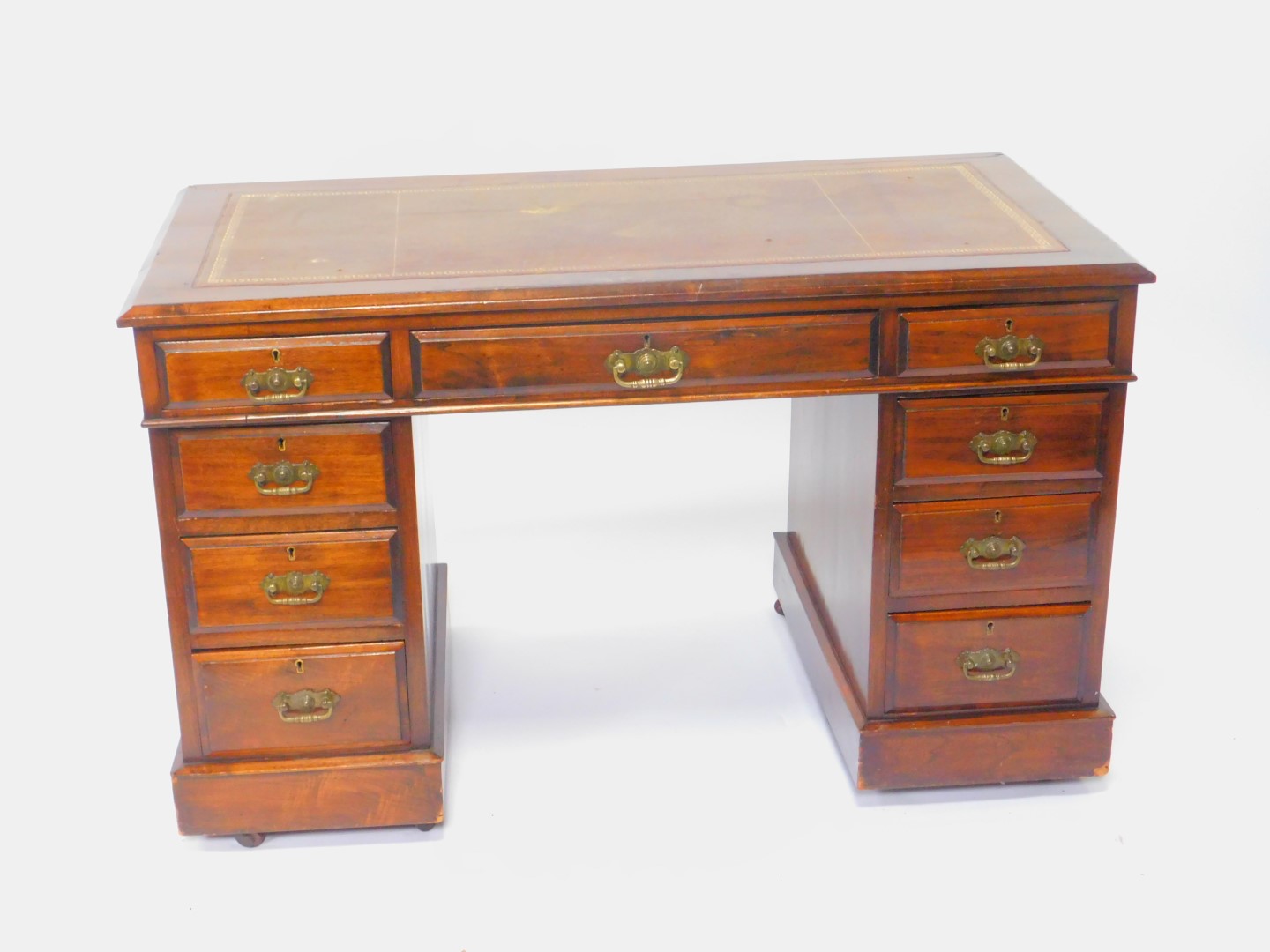 A Victorian mahogany twin pedestal desk, with a tooled leather top, over one long and eight short