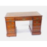 A Victorian mahogany twin pedestal desk, with a tooled leather top, over one long and eight short