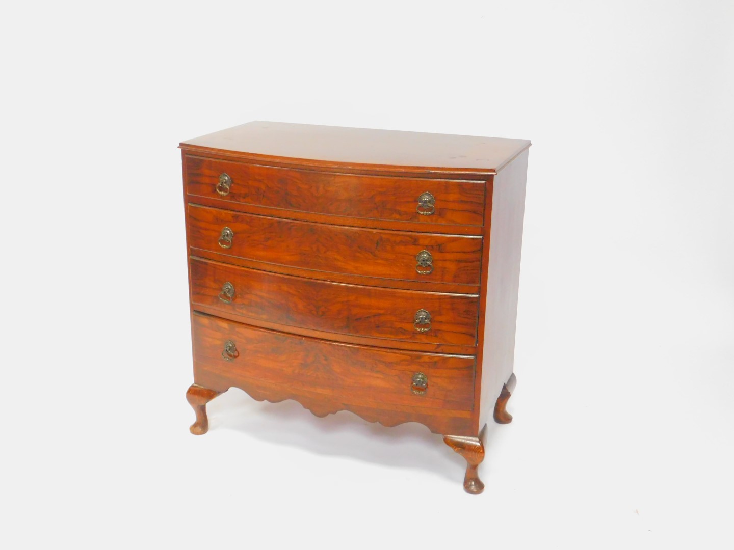 An early 20thC walnut bow front chest, of four long drawers, raised on cabriole legs, 82cm H, 82cm