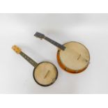 A wooden cased banjo ukulele, and a metal cased banjo ukulele, 59cm and 54cm H respectively. (2)