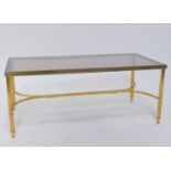 A late 20thC retro brass occasional table of rectangular form, inset glass top, raised on fluted