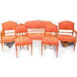 A Victorian mahogany salon suite, upholstered in red and gold foliate fabric, raised on turned legs,