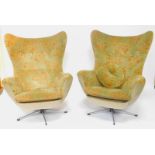 A pair of 1960's wingback egg form swivel armchairs, upholstered in bi-contrast fabric, each 83cm