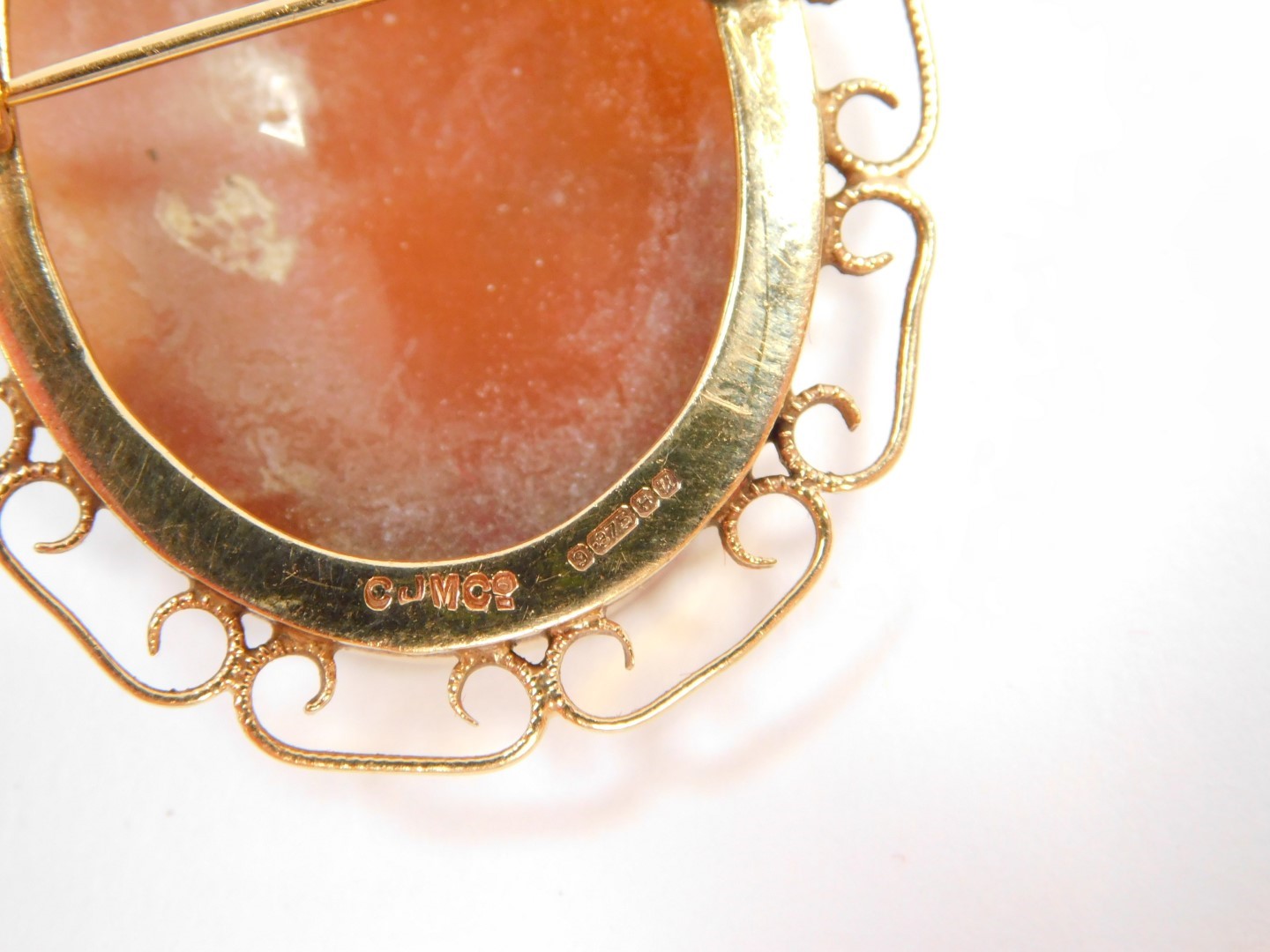 A 9ct gold and shell cameo brooch, bust portrait of a lady, in a 'C' scroll surround. - Image 2 of 2