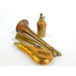 A 19thC brass and copper powder flask, 19cm wide, a further powder flask, 13cm wide and two powder