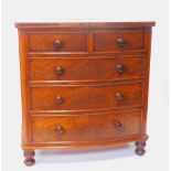 A Victorian mahogany bow front chest, of two short over three long drawers raised on turned feet,