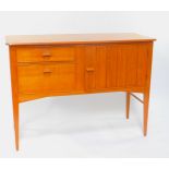 A late 20thC light teak and walnut sideboard, with a grooved panel door, flanked by two graduated