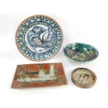 A group of studio pottery, including a terracotta platter painted with a bird, monogrammed M W, 33cm