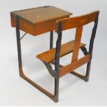 A Victorian oak and cast iron school desk, with integral seat, 88cm High, 61cm Wide, 77cm Deep.