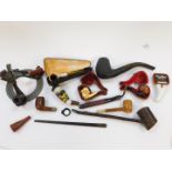 A group of 19thC wooden meerschaum and other pipes, variously carved and decorated, together with