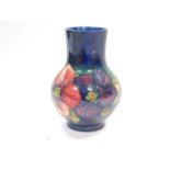A Moorcroft pottery vase decorated in the Anemone pattern, against a cobalt blue ground, impressed
