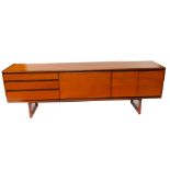 A 1960's White & Newton Ltd teak sideboard, with a central drop down drinks cabinet door, flanked by