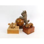 A continental early 20thC treen box and cover, formed as ball surmounted with a figure of a terrier,