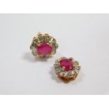 A pair of 9ct gold ruby and diamond set flower head earrings, the rubies oval cut, pin broken and