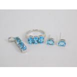 A silver and Swiss blue topaz set of jewellery, comprising three stone ring, size O, pair of