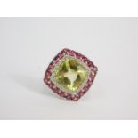 A silver and lemon quartz ring, the cushion shaped quartz, 6.7ct, in a surround of a white topaz and