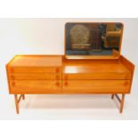 A Merrydew 1960's teak dressing chest, with a rectangular mirror, three narrow and two deep drawers,