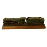 A metal diecast style train model of the Pennsylvanian, in green, on wooden plinth base, 38cm